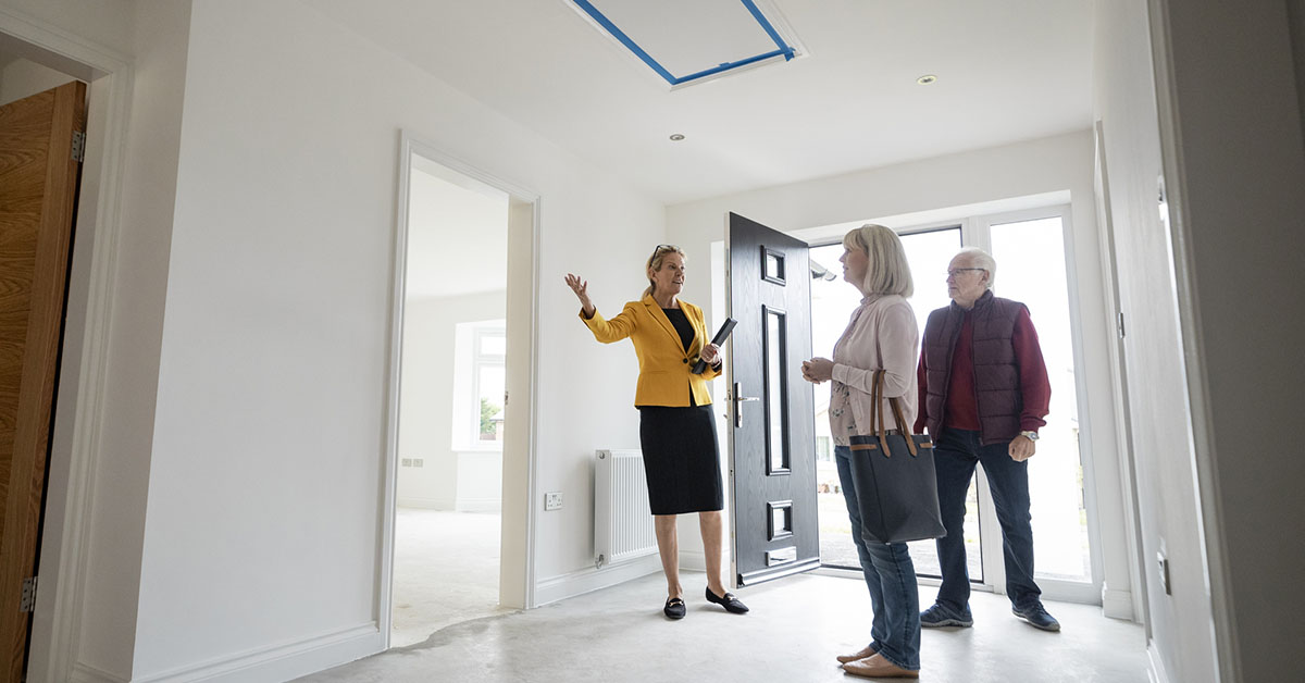 A female agent shows a home to her clients