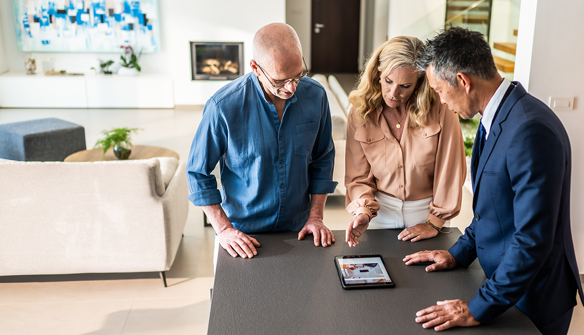 A couple walking through an investment property with an agent